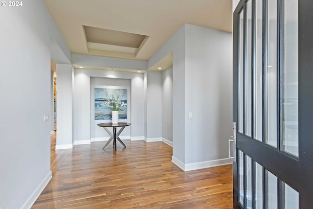 hallway with hardwood / wood-style flooring