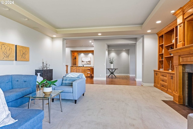 carpeted living room featuring a raised ceiling