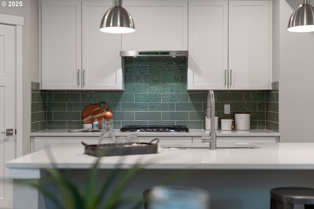 kitchen featuring white cabinets, decorative backsplash, and range hood