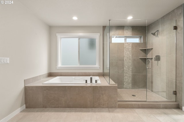 bathroom featuring tile patterned flooring and shower with separate bathtub