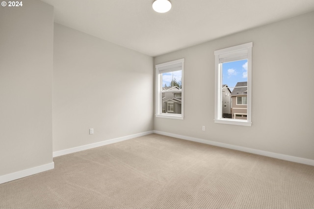 unfurnished room with light carpet