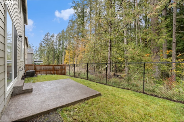 view of yard with cooling unit and a patio