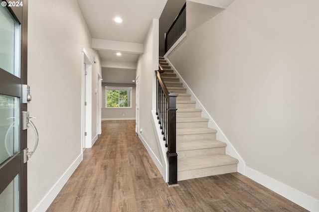 staircase with wood-type flooring