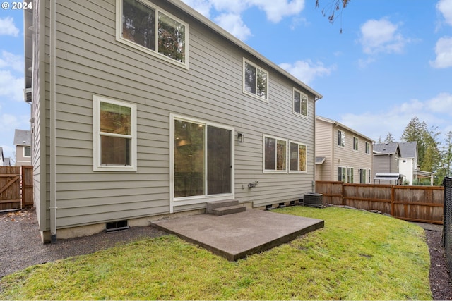 rear view of house with a patio, central AC unit, and a lawn