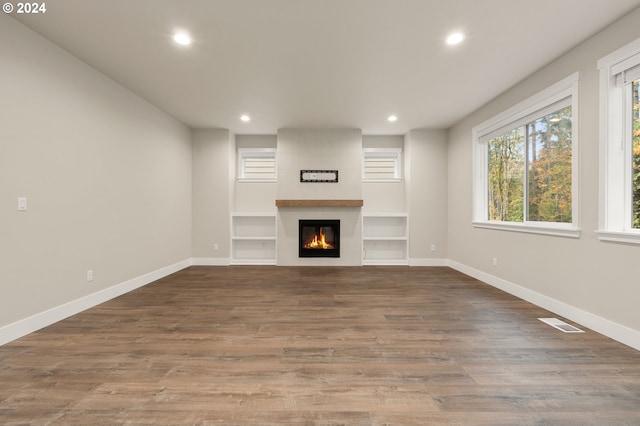 unfurnished living room with a fireplace and wood-type flooring