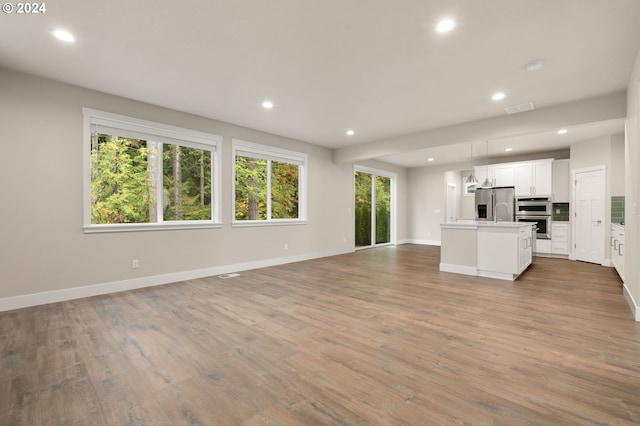 unfurnished living room featuring hardwood / wood-style flooring