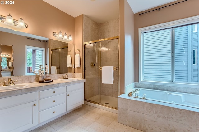 bathroom with shower with separate bathtub, tile patterned floors, and vanity