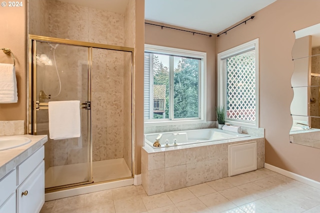 bathroom with tile patterned flooring, independent shower and bath, and vanity