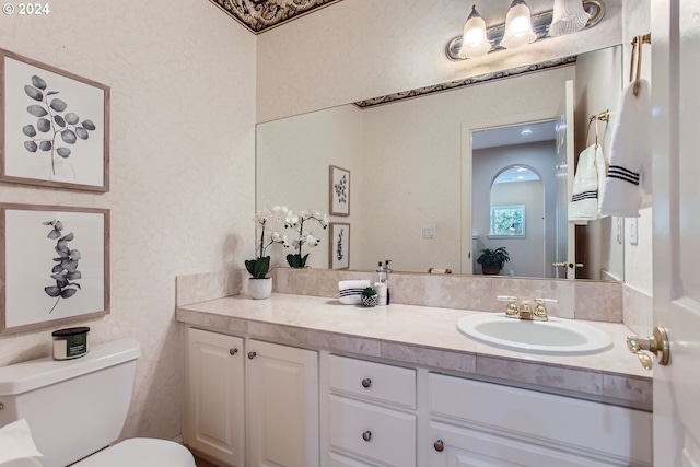 bathroom featuring vanity and toilet