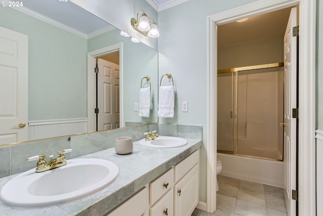 full bathroom featuring vanity, enclosed tub / shower combo, ornamental molding, toilet, and tile patterned floors