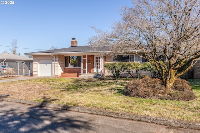 ranch-style house featuring an attached garage, fence, concrete driveway, a chimney, and a front yard