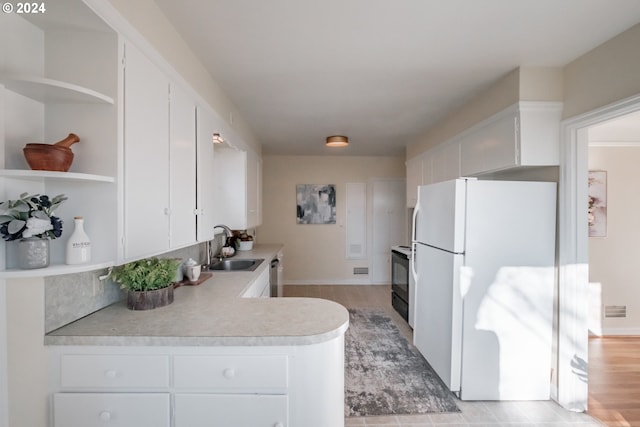 kitchen with light hardwood / wood-style floors, sink, dishwasher, white cabinets, and white fridge