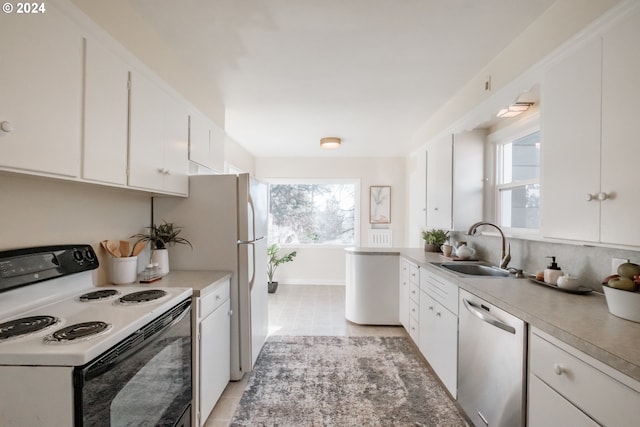 kitchen featuring dishwasher, white cabinets, sink, light tile patterned floors, and white electric range oven