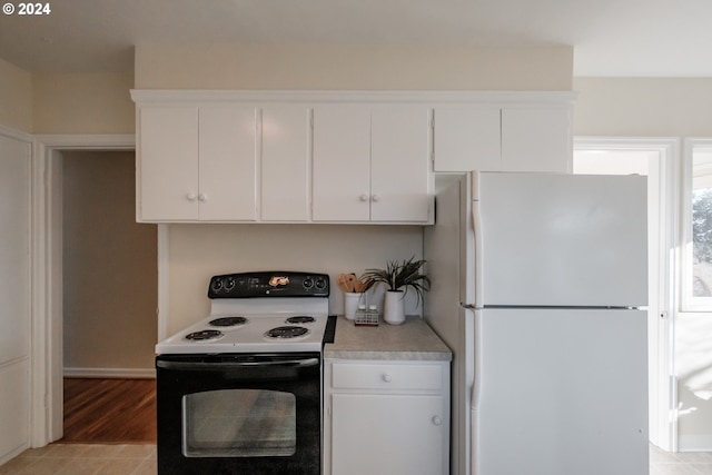 kitchen featuring white cabinets, white appliances, and light tile patterned floors