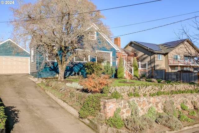 view of front of house with a garage and solar panels