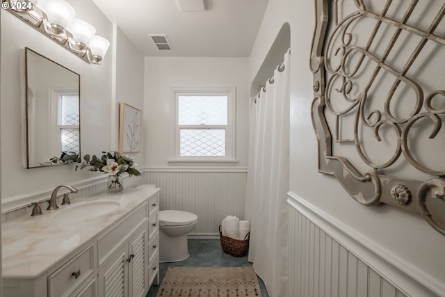 bathroom featuring vanity and toilet