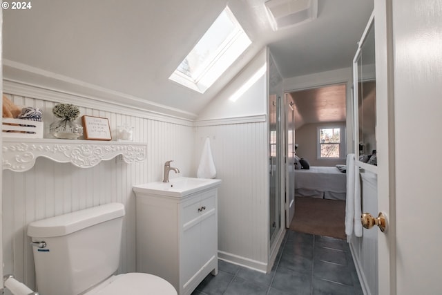 895 Hilltop Dr, Salem, OR 97304 - full bath with a skylight, lofted ceiling, vanity, tile patterned floors, and toilet