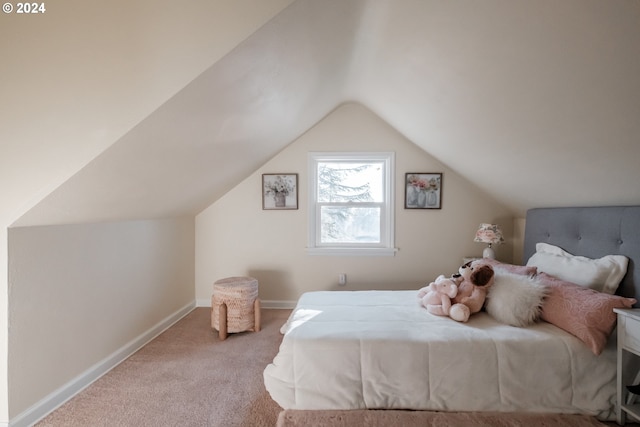 carpeted bedroom with lofted ceiling