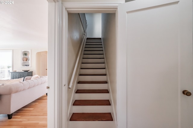 stairs featuring wood-type flooring