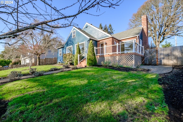 view of front facade featuring a deck and a front yard