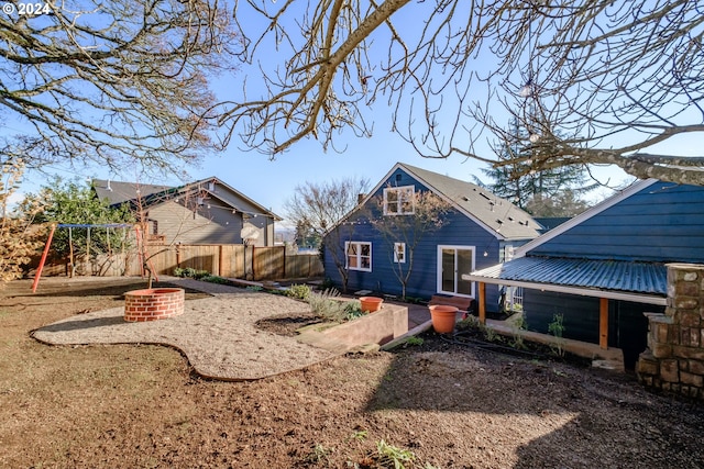 back of property with a playground