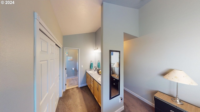 bathroom with vanity and vaulted ceiling