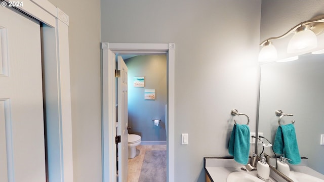 bathroom featuring vanity and toilet