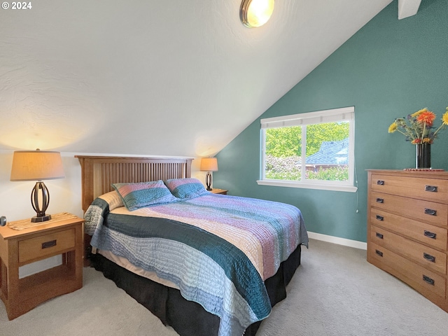 carpeted bedroom with vaulted ceiling