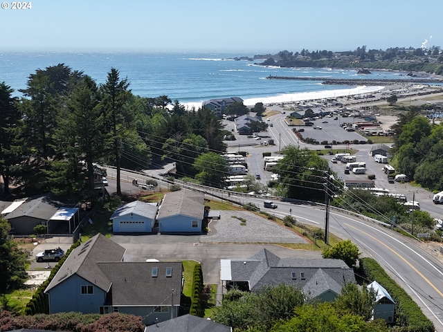 birds eye view of property with a view of the beach and a water view