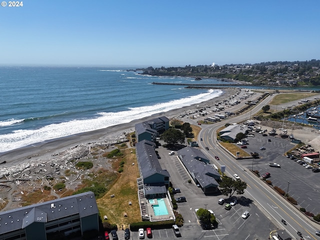 drone / aerial view featuring a beach view and a water view