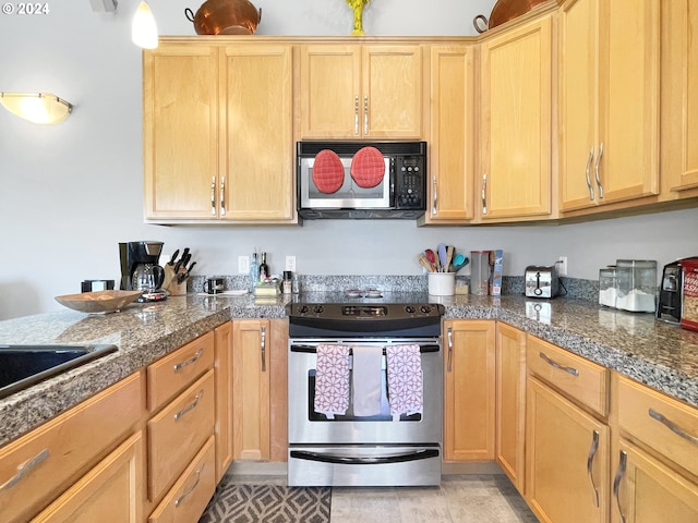 kitchen with stainless steel range with electric cooktop