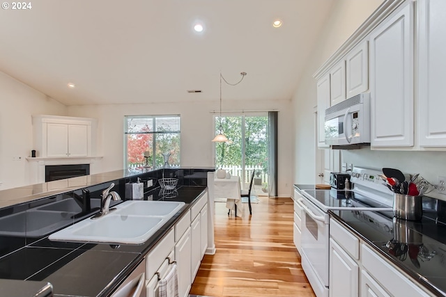 kitchen featuring light hardwood / wood-style flooring, sink, pendant lighting, white cabinets, and white appliances