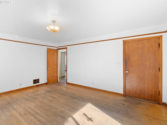 empty room with light hardwood / wood-style floors