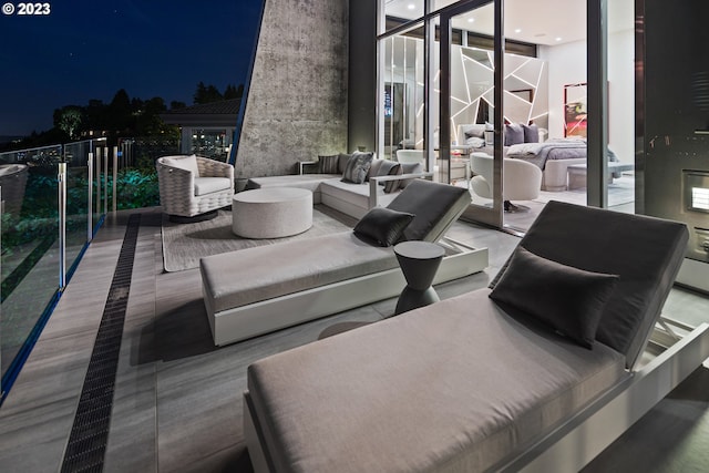 patio terrace at twilight with a balcony and an outdoor hangout area