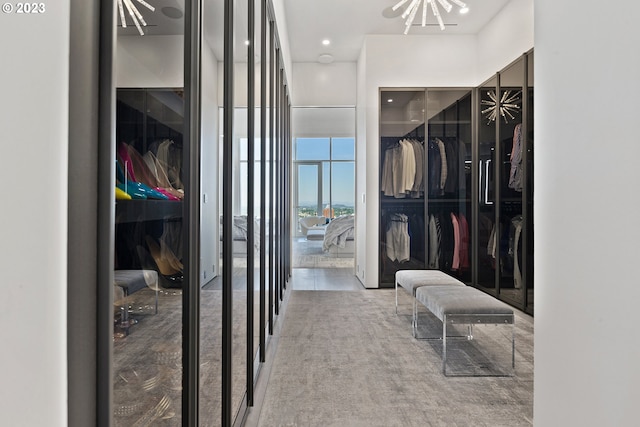 walk in closet featuring light colored carpet