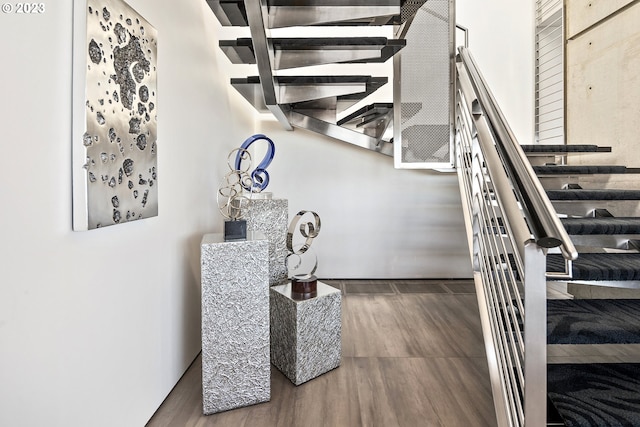 staircase with dark hardwood / wood-style floors