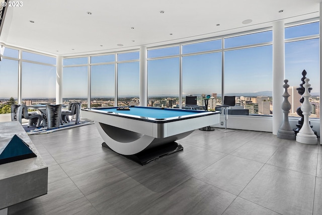 rec room featuring a wall of windows, light tile floors, and pool table