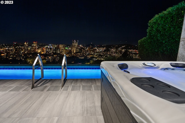 exterior space featuring an outdoor hot tub