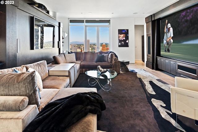 living room featuring floor to ceiling windows and hardwood / wood-style flooring