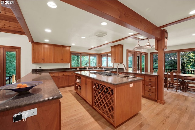 kitchen featuring sink, beam ceiling, and kitchen peninsula