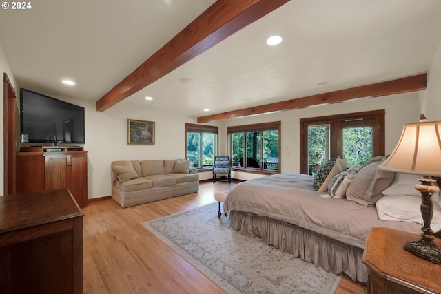 bedroom featuring beam ceiling, access to exterior, and light wood-type flooring