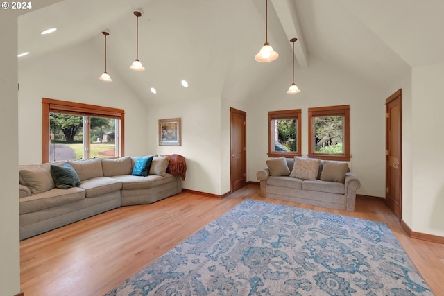 living room featuring beamed ceiling, high vaulted ceiling, and light hardwood / wood-style flooring