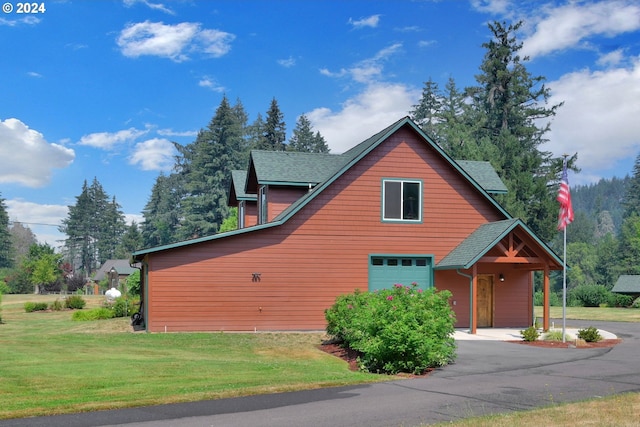 view of home's exterior featuring a garage and a yard