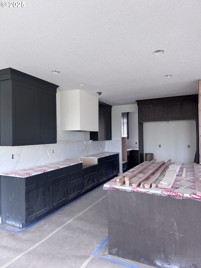 3734 Landis St, West Linn, OR 97068 - kitchen with backsplash, a textured ceiling, and dark cabinetry