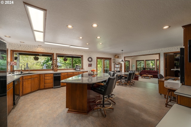 kitchen with plenty of natural light, light colored carpet, and sink