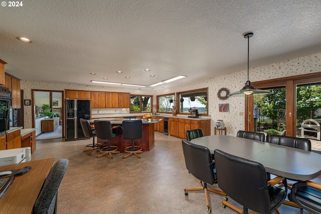 dining space with a textured ceiling