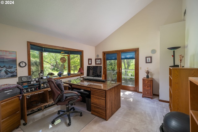 carpeted office with french doors and high vaulted ceiling