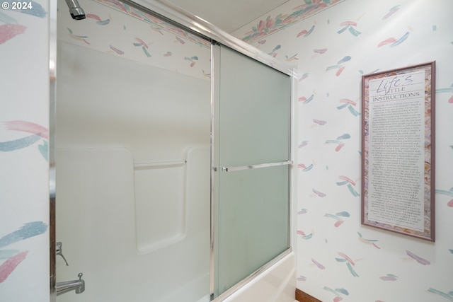 bathroom with bath / shower combo with glass door