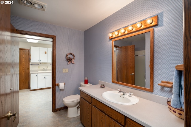 bathroom with vanity and toilet