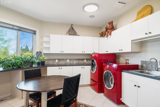 laundry area with hookup for a washing machine, cabinets, light tile flooring, independent washer and dryer, and sink